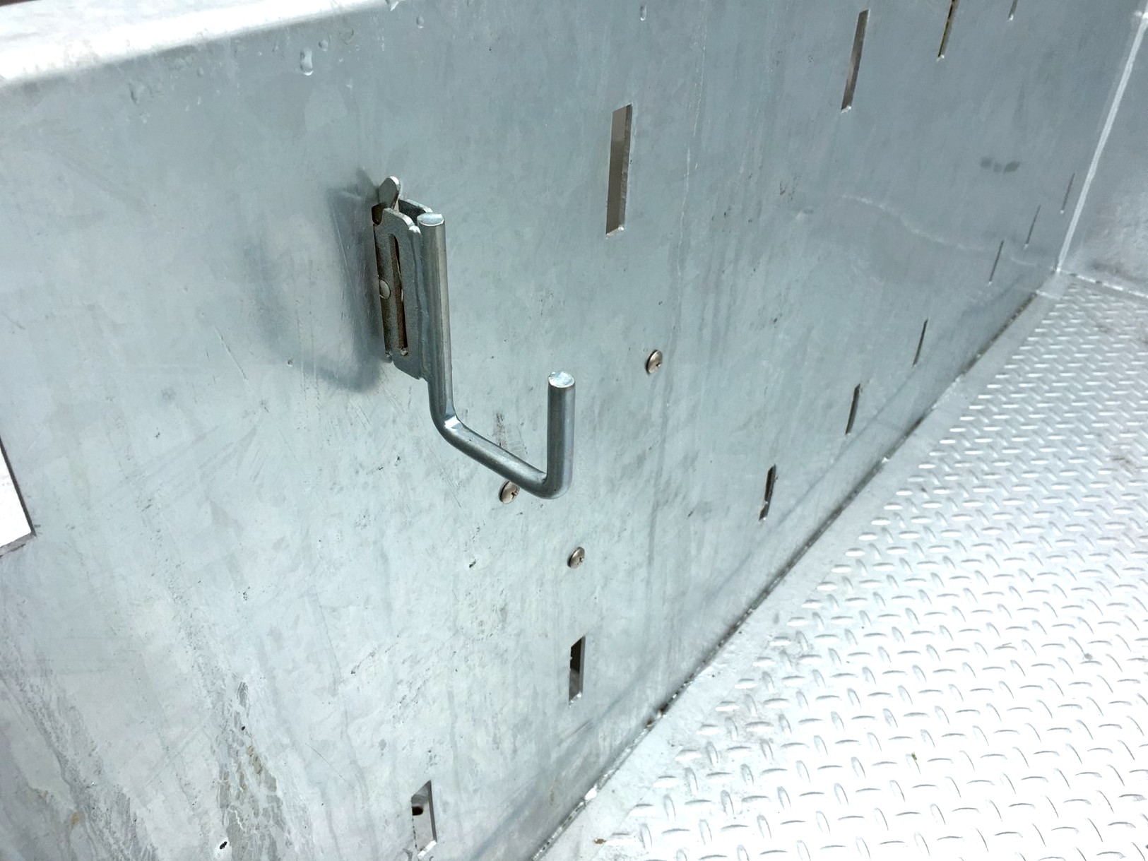 Close view of a galvanized Sauber Mfg. Co. LogiPerf Trailer Side showing a non-rusting material hook installed.