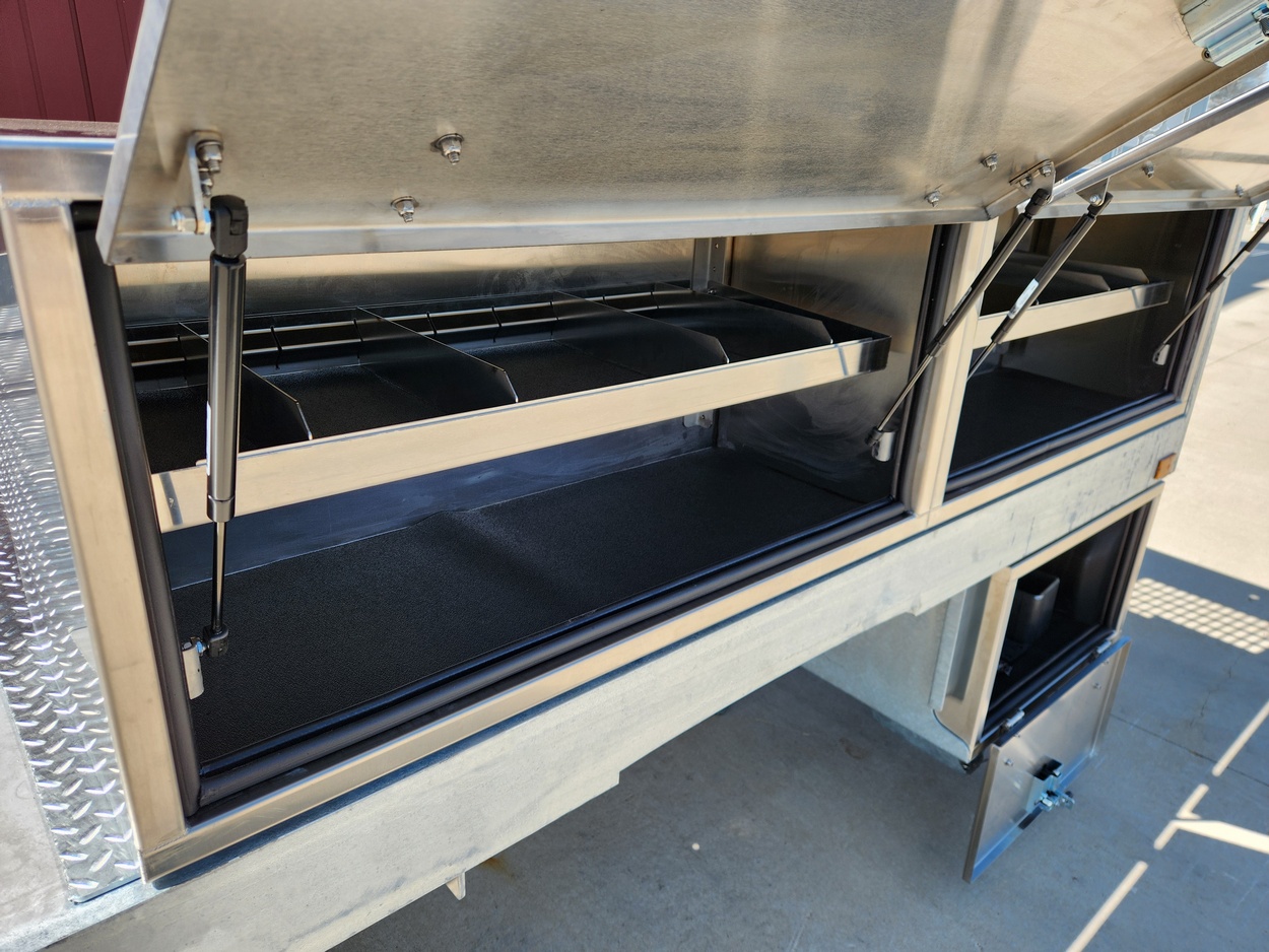 Sauber Mfg. Co. Platform mounted Stainless-Steel Toolbox with 14 gauge material, gas shocks and adjustable divider shelves.